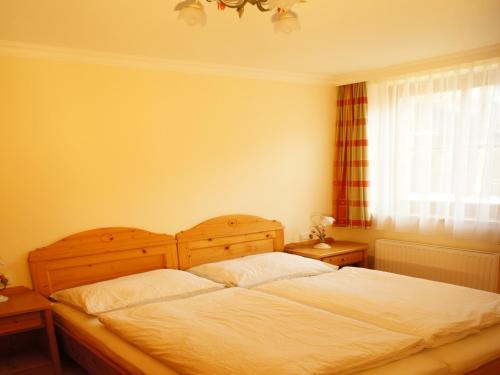 a bedroom with a large bed and a window at Appartement Haus Seer in Wagrain