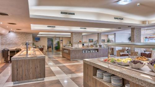 a cafeteria with a buffet line with food at Hotel Golden Dune in Sunny Beach