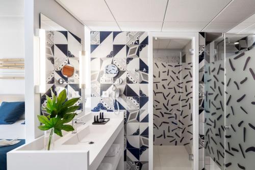 a bathroom with blue and white tiles on the wall at AQUA Hotel Onabrava & Spa 4*Sup in Santa Susanna