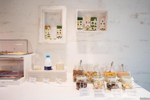 a table with jars of food on a counter with a counter at Hotel Solemare in Milano Marittima