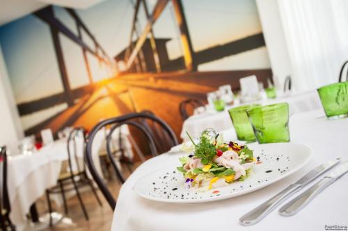 a plate of food on a table in a restaurant at Hotel Solemare in Milano Marittima
