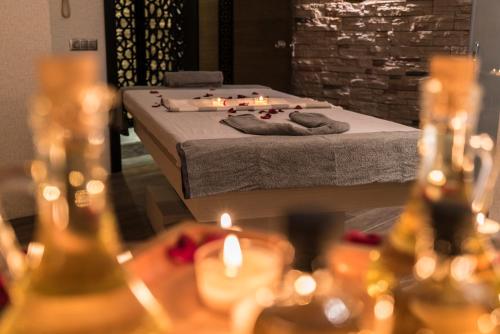 a bed in a room with candles in front of it at Mirart Hotel Boutique & SPA Yalova in Yalova