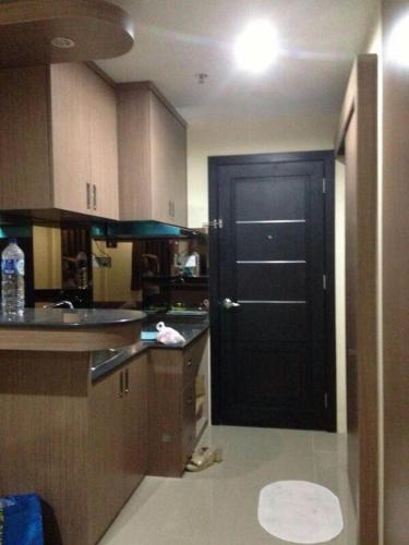 a kitchen with a black door leading into a kitchen at Studio unit Nagoya Mansion Batam in Nagoya
