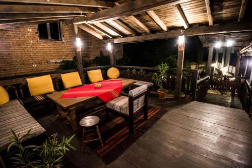 a patio with a table and chairs on a deck at Banskovilla Zlateva House in Bansko