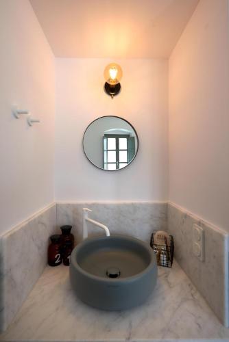 a bathroom with a large tub in the corner at Argonauta Hotel in Parikia