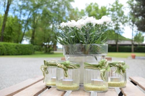 a vase with flowers in it sitting on a table at Tenuta Ajrale in Vigone