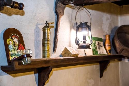 a shelf with a lamp and a picture on it at Banskovilla Zlateva House in Bansko