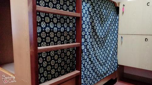a shelf with a bunch of blue and white ties at Matsu 1st Hostel in Nangan
