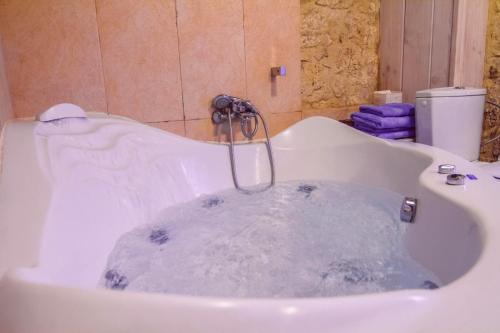 a bath tub filled with water in a bathroom at Torre San Martín in Quintana de Valdivielso