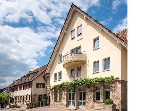 a large white building with a balcony at Weinstadt Hotel - das Original in Weinstadt
