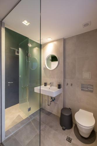 a bathroom with a toilet and a sink and a shower at R34 Boutique Hotel in Sofia