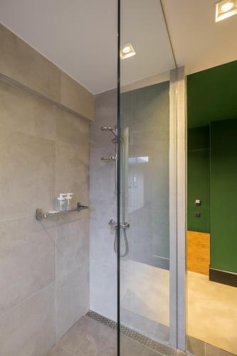a shower with a glass door in a bathroom at R34 Boutique Hotel in Sofia