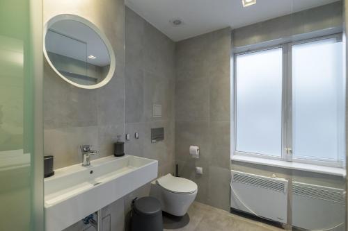 a bathroom with a sink and a toilet and a mirror at R34 Boutique Hotel in Sofia