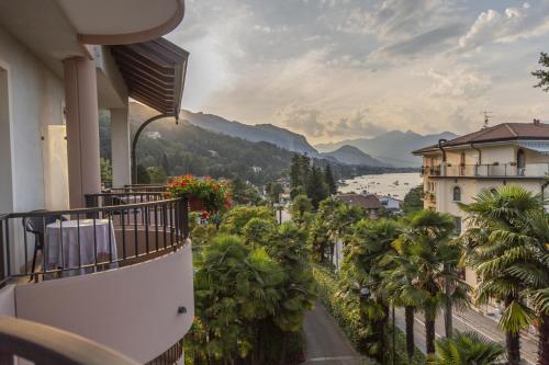 a balcony of a building with a view of a river and mountains at Hotel Della Torre in Stresa