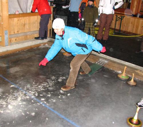 a man riding a skateboard in a room at Gästehaus Lanzinger in Liesing
