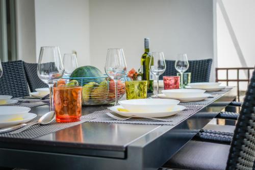a table with plates and wine glasses on it at Guesthouse Klara in Duba Stonska