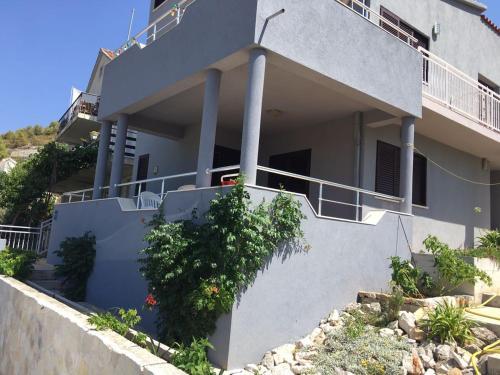 a house with stairs and plants in front of it at Vila Sunce Vis in Vis