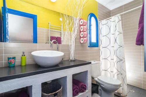 a bathroom with a sink and a toilet at Casa14 in Frigiliana