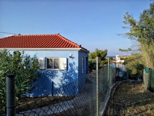 a small blue house behind a fence at Home by the sea in Monemvasia