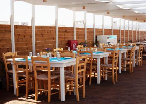a row of tables and chairs in a room at Capsis Astoria Heraklion in Heraklio Town