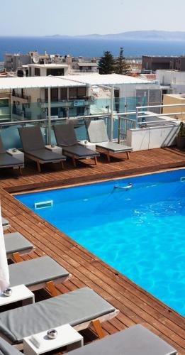 a swimming pool on the roof of a building at Capsis Astoria Heraklion in Heraklio Town