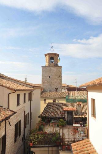 a building with a clock tower on top of it at GG8 Hotel & Suite SPA in Gualdo Tadino