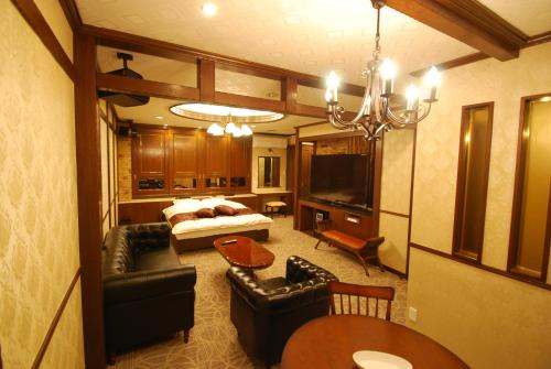 a large living room with a bed and a couch at Hotel Free Style Okayama in Okayama