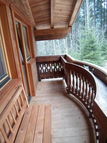 a wooden staircase in a log cabin with trees at Ferienwohnung Steiner in Wald im Pinzgau