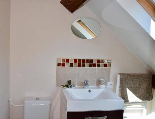 a bathroom with a sink and a toilet at Libellule in Coussac-Bonneval