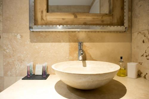 a bathroom with a white sink and a mirror at Brewer's Cottage - Brosterfield Farm in Eyam