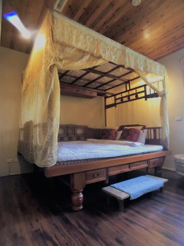 a bed with a mosquito net on top of it at Jiji Village Villa B&B in Lugu Lake