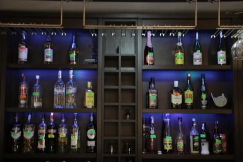 a shelf filled with lots of bottles of alcohol at Hanul lui Țintă in Buzău