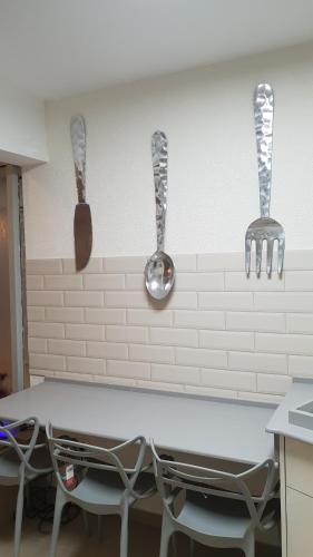 two utensils hanging on a wall above a kitchen counter at Amazing in Haifa