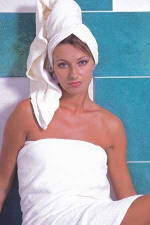 a woman in a white towel on her head at Appartementhaus Bergland in Obsteig