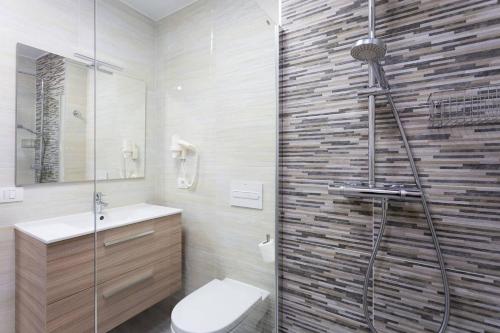 a bathroom with a shower and a toilet and a sink at atlantico in Costa Del Silencio