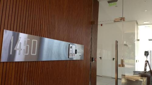 a sign on a wooden door in a building at Aizarker in La Plata