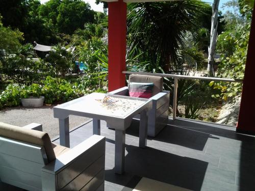 a table and chairs sitting on a patio with a view at Don Genaro Apartments in Barber