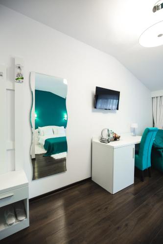 a room with a bed and a mirror on the wall at Gorgeous Villa in Cluj-Napoca