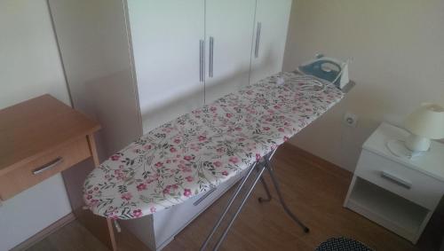 a hospital bed with a blanket on it in a room at Apartment Stanko in Ližnjan