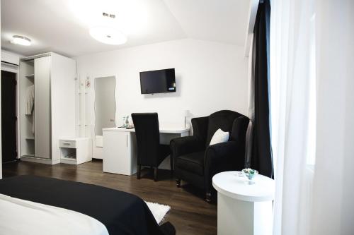a room with a bed and chairs and a desk at Gorgeous Villa in Cluj-Napoca
