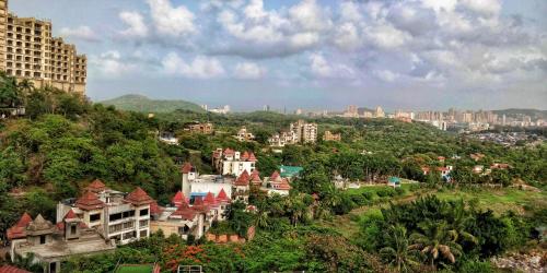 a town on a hill with buildings and trees at Villa 408-Dr Wade in Royal Palms Mumbai in Mumbai