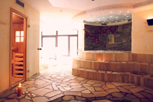a room with a stone floor and a stone wall at Pippo Hotel in Terzolas