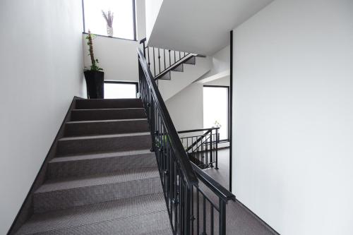a staircase in a house with white walls at Gorgeous Villa in Cluj-Napoca