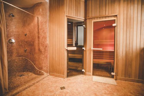 a bathroom with a walk in shower and a walk in shower at Kurhotel & Hotel Mozart in Bad Gastein