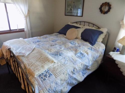a bedroom with a bed with a teddy bear on it at StoneWall House in Lake Elmo