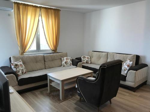 a living room with a couch and a table at Apartmani Belma in Dobra Voda