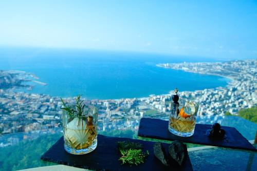 two vases sitting on a table with a view of a city at Bay Lodge Boutique Hotel in Jounieh