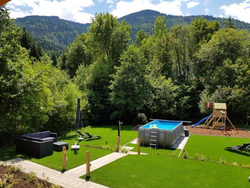 an aerial view of a garden with a playground at Ferienhäuser Glück Auf, Sauna, Hottubs in Arnoldstein