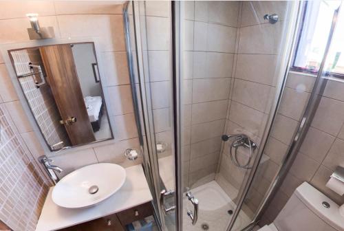 a bathroom with a shower and a sink at Lili Hotel in Amoudara Herakliou