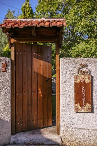 an entrance to a wooden gate with a wooden roof at Filoxenia- Drakia in Drakeia